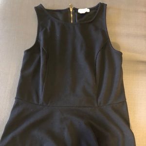Black peplum tank with a zip back